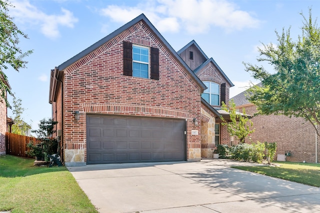 view of front property featuring a front lawn and a garage