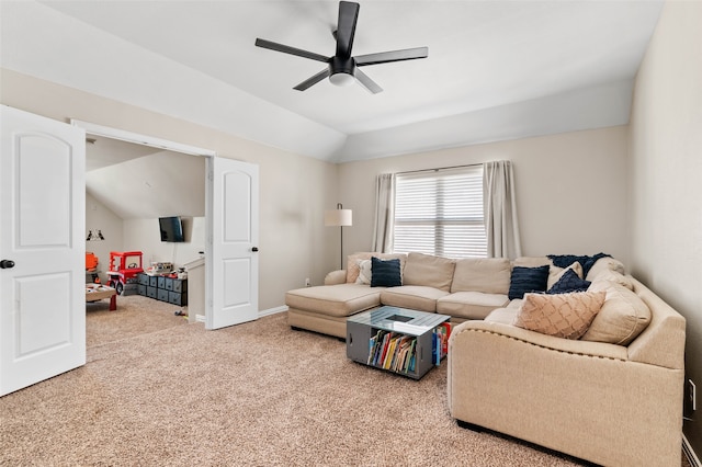 carpeted living room featuring ceiling fan and vaulted ceiling