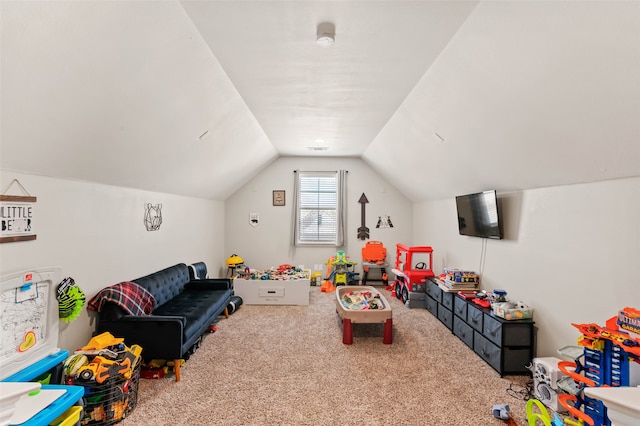 rec room featuring carpet flooring and vaulted ceiling