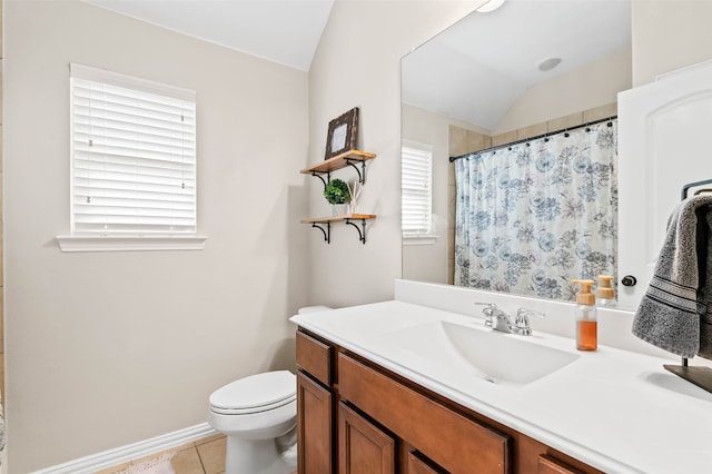 bathroom with toilet, a wealth of natural light, vanity, and vaulted ceiling