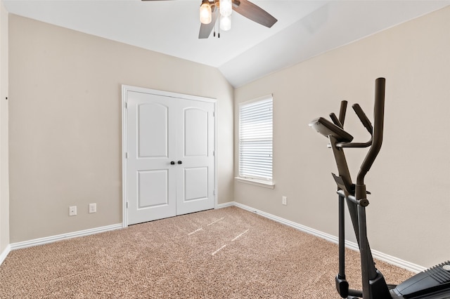 workout room with ceiling fan, vaulted ceiling, and carpet floors