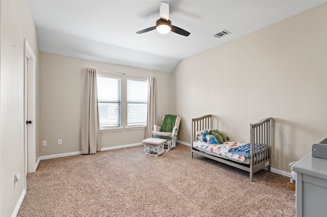 bedroom with ceiling fan, lofted ceiling, and carpet floors