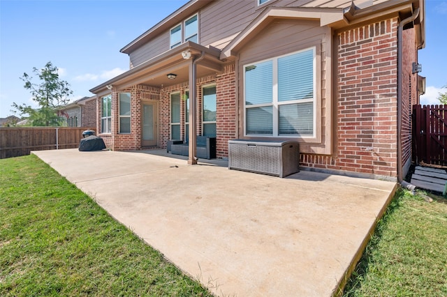 back of property featuring a patio area and a lawn