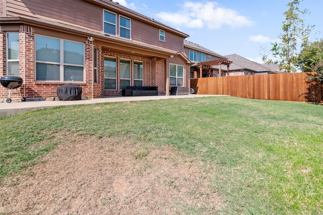 back of house featuring a patio and a lawn