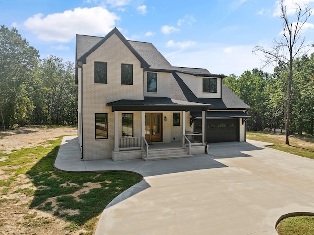 view of front of home with a garage and a porch