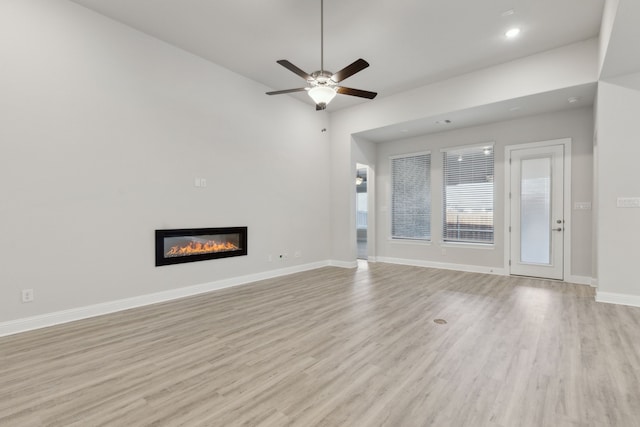 unfurnished living room with ceiling fan and light hardwood / wood-style flooring