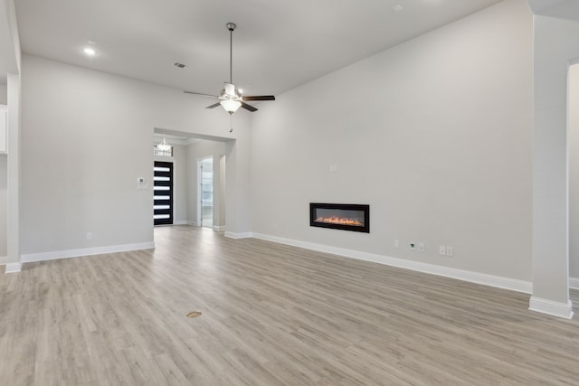 unfurnished living room featuring light hardwood / wood-style floors and ceiling fan