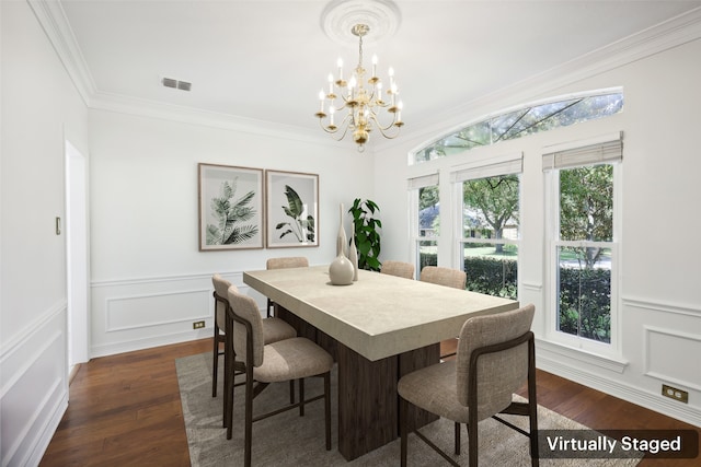 dining room with a chandelier, dark hardwood / wood-style floors, and crown molding