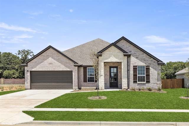 view of front of property with a front lawn and a garage