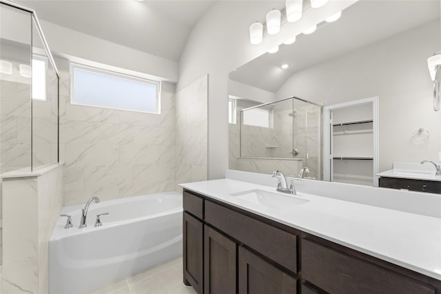 bathroom with vanity, vaulted ceiling, and shower with separate bathtub