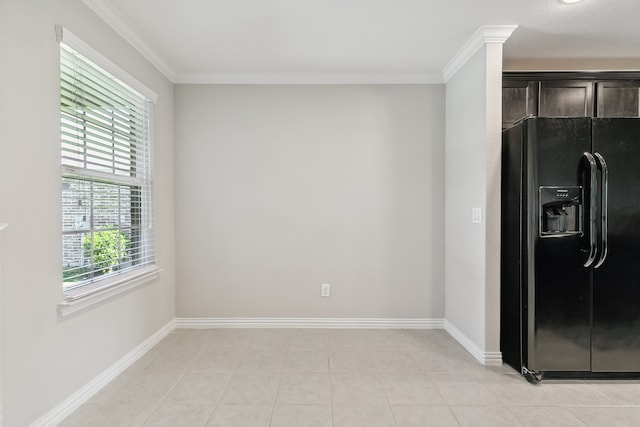 kitchen with crown molding, a wealth of natural light, and black fridge