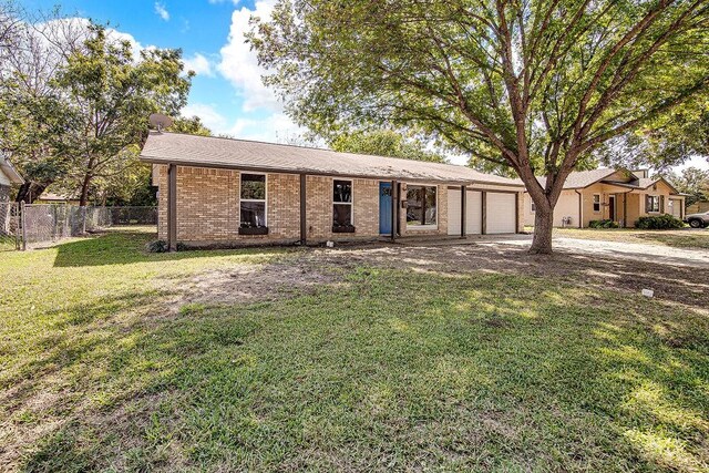 ranch-style house with a front yard and a garage