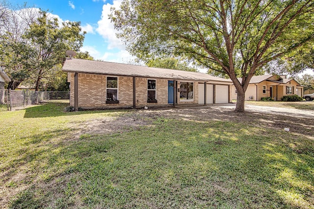 ranch-style house featuring a front yard and a garage