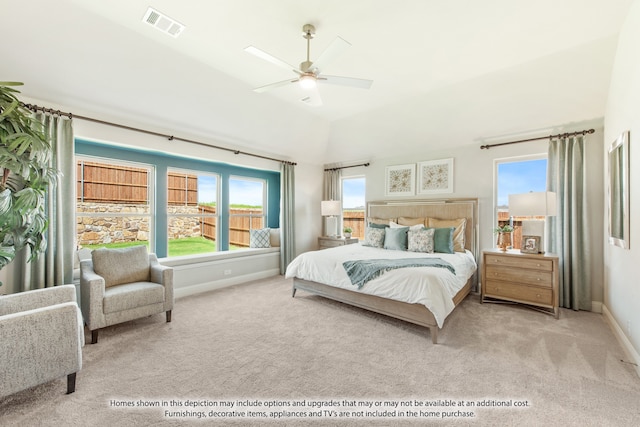 bedroom with ceiling fan, light colored carpet, and vaulted ceiling