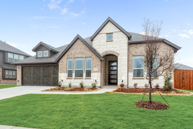 view of front of house with driveway, stone siding, a front yard, and brick siding