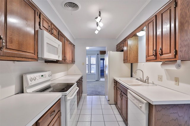 kitchen with light tile patterned floors, white appliances, ornamental molding, and sink