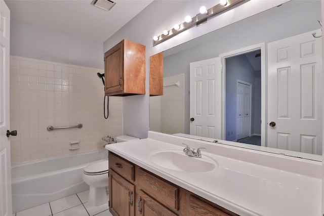 full bathroom featuring tile patterned flooring, vanity, toilet, and tiled shower / bath