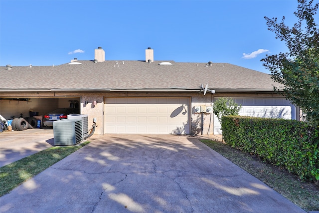 view of property exterior with a garage and central air condition unit