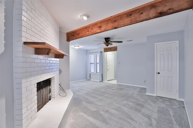 carpeted living room featuring beamed ceiling, a brick fireplace, and ceiling fan