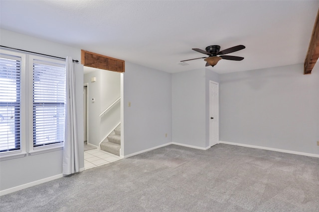 carpeted empty room featuring ceiling fan