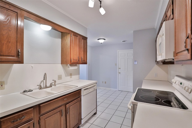 kitchen with light tile patterned floors, white appliances, and sink