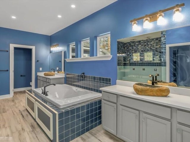 bathroom with vanity, toilet, walk in shower, and wood-type flooring