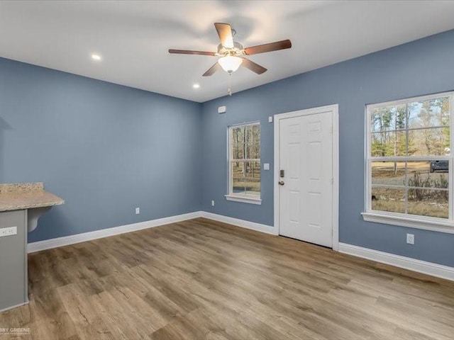 interior space with ceiling fan and wood-type flooring