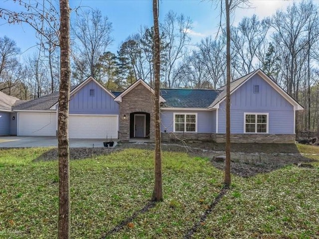 ranch-style home with a garage and a front lawn