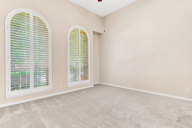 empty room with light carpet and ceiling fan