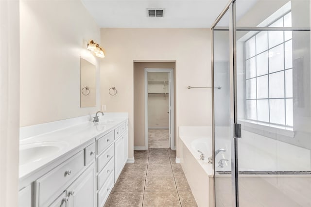 bathroom with tile patterned flooring, separate shower and tub, and vanity