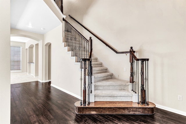 stairway featuring wood-type flooring