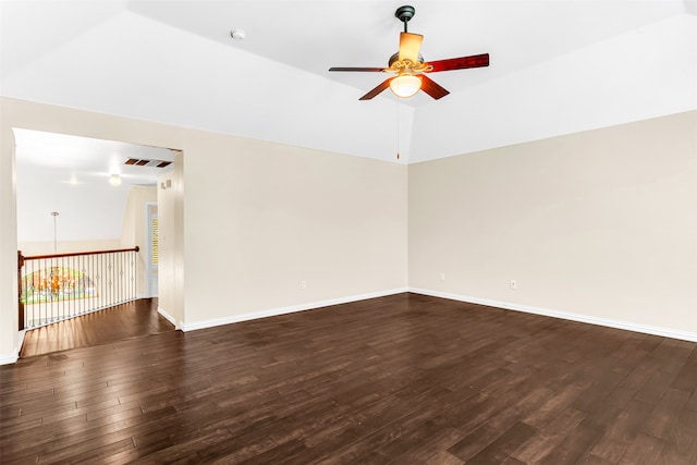 spare room with lofted ceiling, dark hardwood / wood-style floors, and ceiling fan