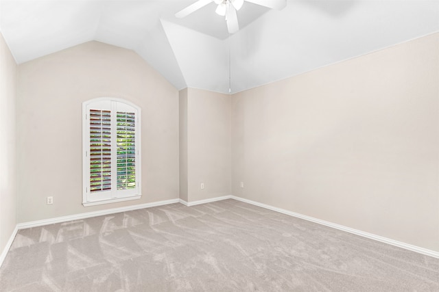 unfurnished room with light carpet, ceiling fan, and vaulted ceiling