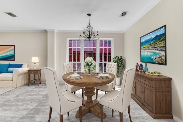 dining area with ornamental molding, a chandelier, and light colored carpet