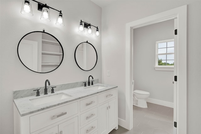 bathroom with tile patterned floors, vanity, and toilet