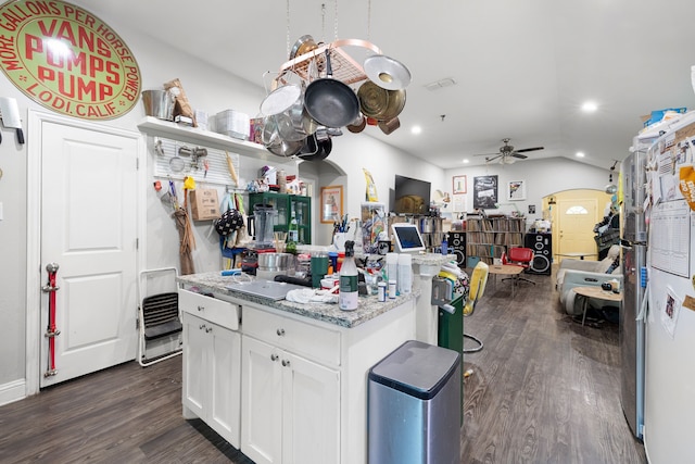 kitchen with white cabinetry, dark hardwood / wood-style floors, ceiling fan, and light stone counters