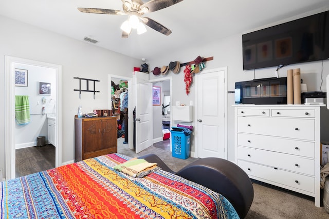 bedroom featuring dark carpet, ensuite bath, a closet, and ceiling fan