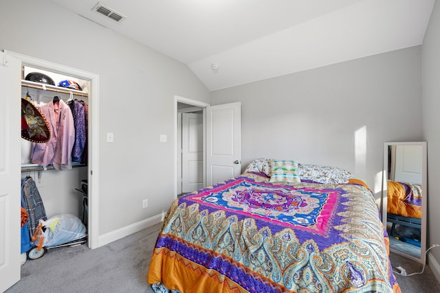 carpeted bedroom featuring vaulted ceiling and a closet