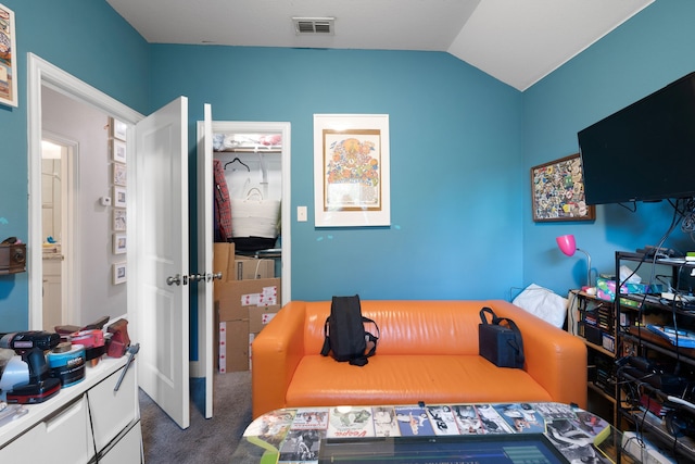 bedroom with dark colored carpet, vaulted ceiling, and a closet