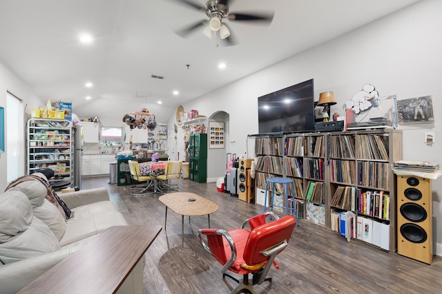 living room featuring lofted ceiling, dark hardwood / wood-style floors, and ceiling fan