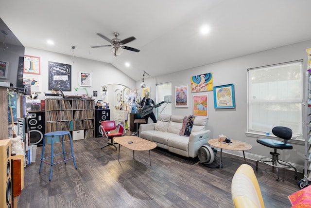 living room with ceiling fan, dark hardwood / wood-style floors, and vaulted ceiling