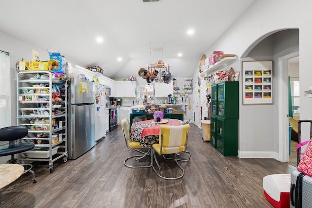 kitchen featuring stainless steel appliances, dark hardwood / wood-style floors, vaulted ceiling, and white cabinets