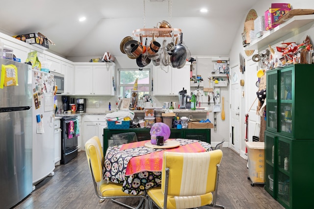 kitchen featuring lofted ceiling, stainless steel refrigerator, backsplash, black range with electric cooktop, and white cabinets