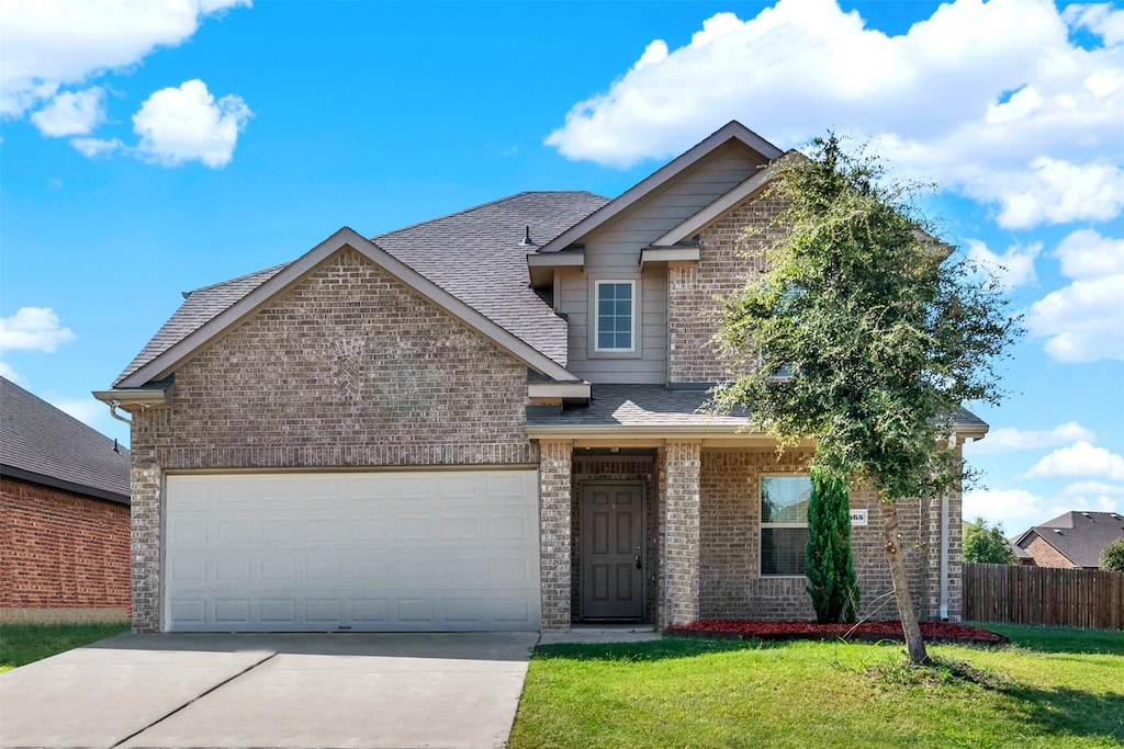 view of front facade with a front yard and a garage