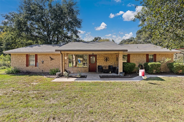 back of house featuring a patio and a lawn