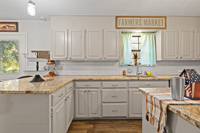 kitchen featuring white cabinetry, a healthy amount of sunlight, sink, and dark hardwood / wood-style floors