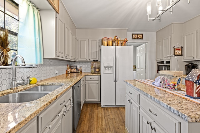 kitchen with light hardwood / wood-style floors, white cabinets, sink, and white refrigerator with ice dispenser