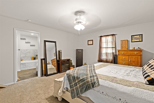 carpeted bedroom with ceiling fan and ensuite bathroom