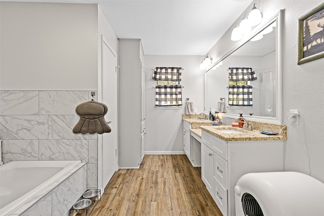 bathroom featuring vanity, hardwood / wood-style floors, and a bathtub