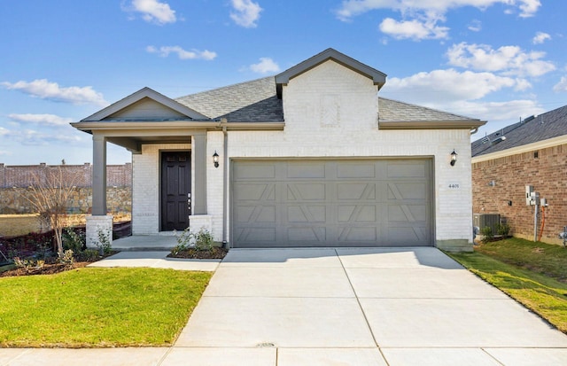 view of front of property with a garage and a front lawn